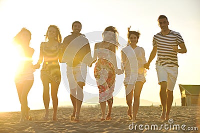 Happy people group have fun and running on beach