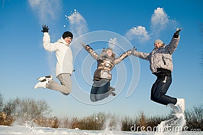 Happy people jumping in winter