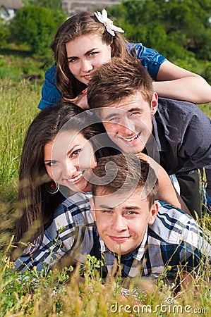 Happy pile: group of Young people & green field