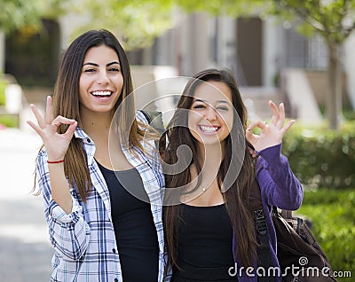 Happy Same-Sex Mixed Race Couple on School Campus With Okay Sign