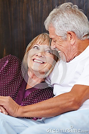 Happy senior couple in bed