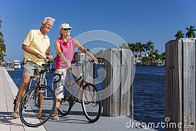 Happy Senior Couple on Bicycles By a River