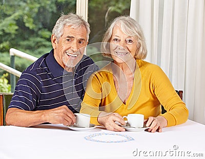 Happy senior couple drinking coffee