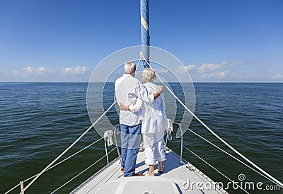 Happy Senior Couple On Front of a Sail Boat