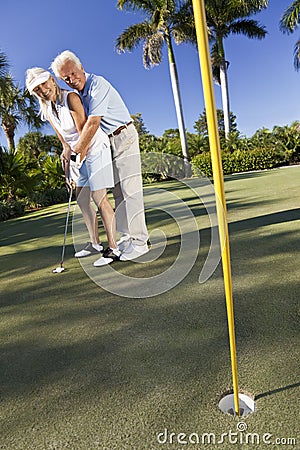 Happy Senior Couple Playing Golf & Putting