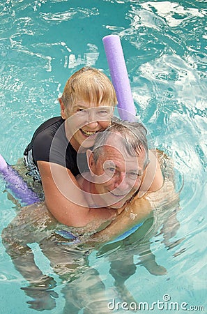 Happy senior couple in pool