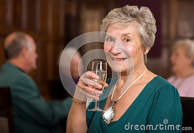 Happy senior lady in restaurant