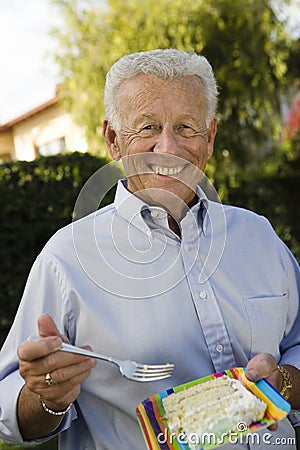 Happy Senior Man Eating Cake