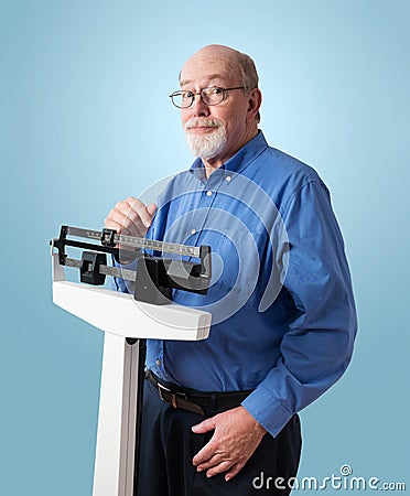Happy Senior Man on Weight Scale