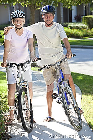 Happy Senior Man & Woman Couple on Bicycles