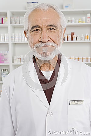 Happy Senior Pharmacist In Shop