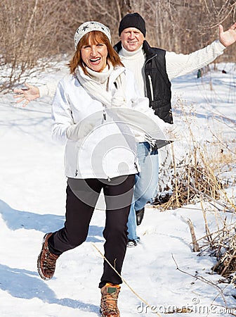 Happy seniors couple in winter park