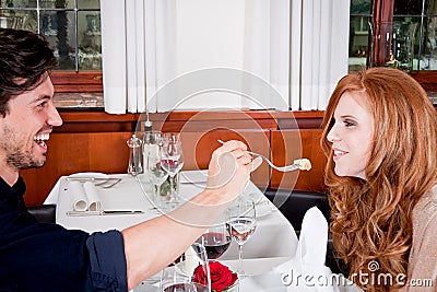 Happy smiling couple in restaurant celebrate