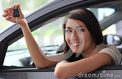 Happy smiling woman with car key
