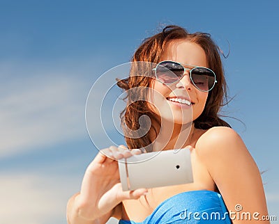 Happy smiling woman using phone camera