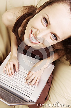 Happy student at home with laptop