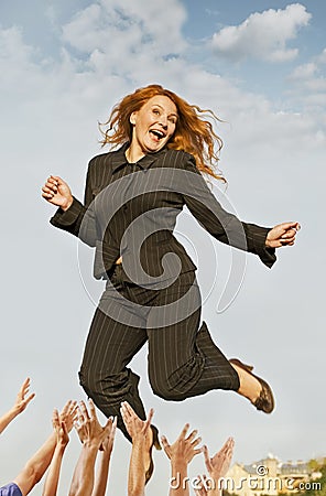 Happy successful business woman jumping