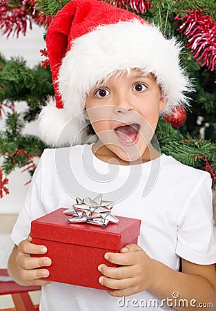 Happy surprised kid with christmas present