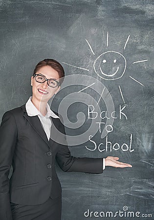 Happy teacher and smiling sun on the chalkboard