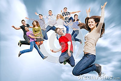 Happy teenage friends jumping in the sky