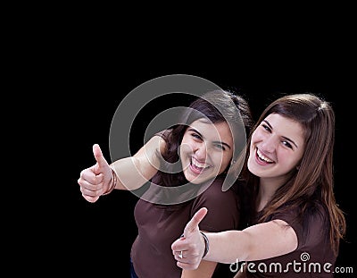 Happy teenagers giving thumbs up sign