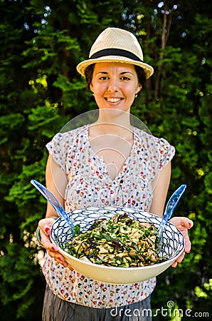 Happy vegetarian woman with salad