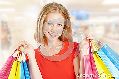 Happy woman with bag on a shopping in the mall