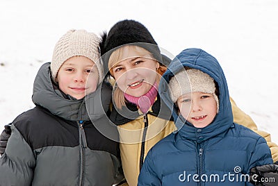 Happy woman and cheerful boys in winter