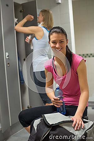 Happy woman at gym s locker room