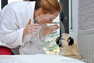 Happy woman with her pug dog