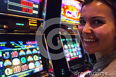 Happy woman near slot machines