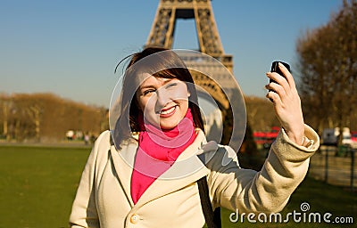 Happy woman in Paris using phone camera