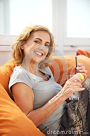 Happy woman relaxing with a drink at a restaurant
