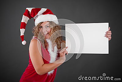 Happy woman in Santa hat holding blank sign