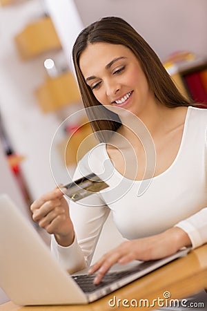 Happy Woman shopping online with credit card and computer.Intern