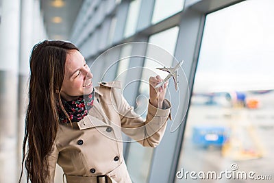 Happy woman with small model airplane inside