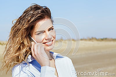 Happy woman smiling on the mobile phone