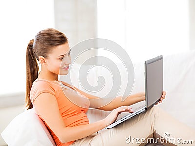 Happy woman using laptop at home