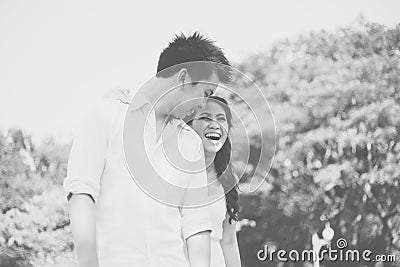 Happy young asian couple in a park