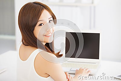 Happy young asian woman using a laptop