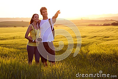 Happy Young couple on the field in spring