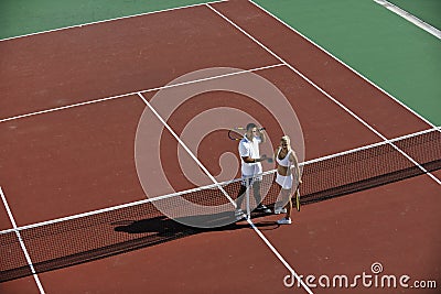 Happy young couple play tennis game outdoor