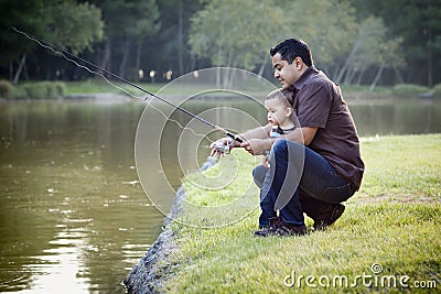 Happy Young Ethnic Father and Son Fishing