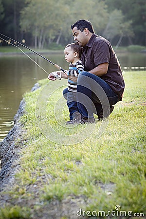 Happy Young Ethnic Father and Son Fishing