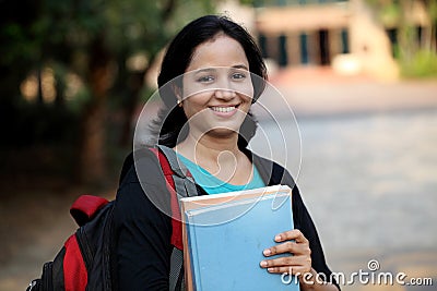 Happy young female student at college campus