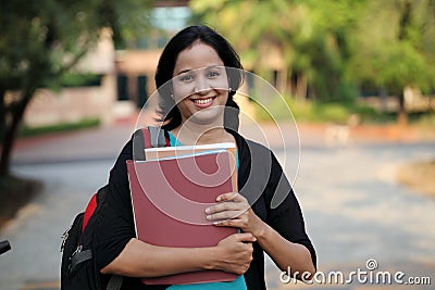 Happy young female student at college campus