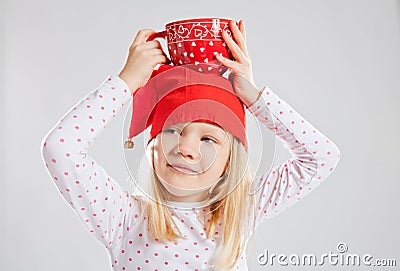 Happy young girl holding big cup on head