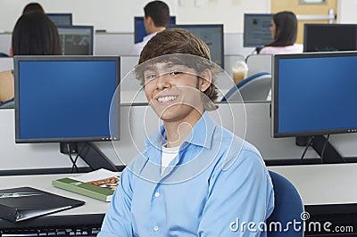 Happy Young Male Student In Computer Lab