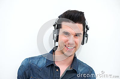 Happy young man listening to music and smiling