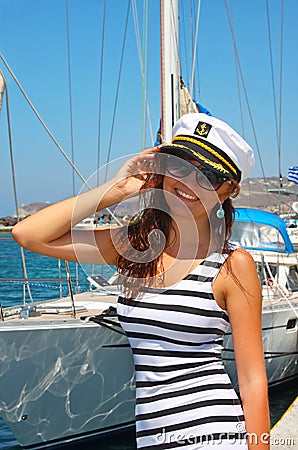 Happy young woman in cap captain